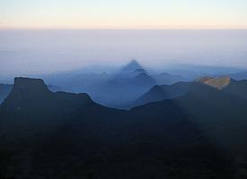 The cone-shaped shadow of "Adam's Peak" above the morning mist